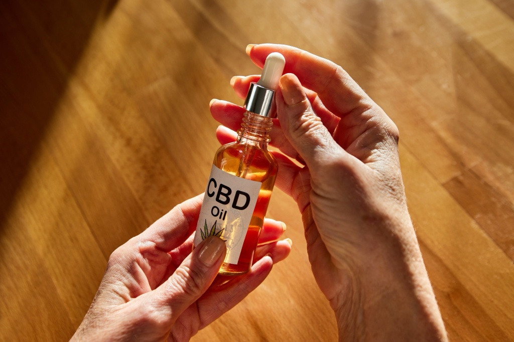 opening bottle of CBD oil