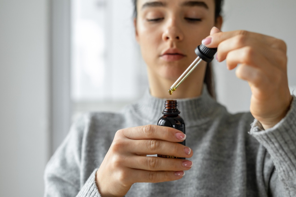 woman looking at cannabis oil cbd vs cbg