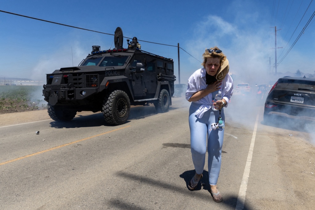 protestor during ice raid at glass house farms
