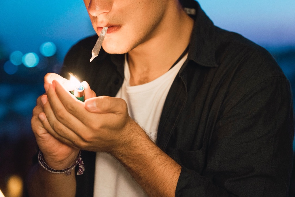 man smoking cannabis joint DNA study suggests genes play a role in how people use weed