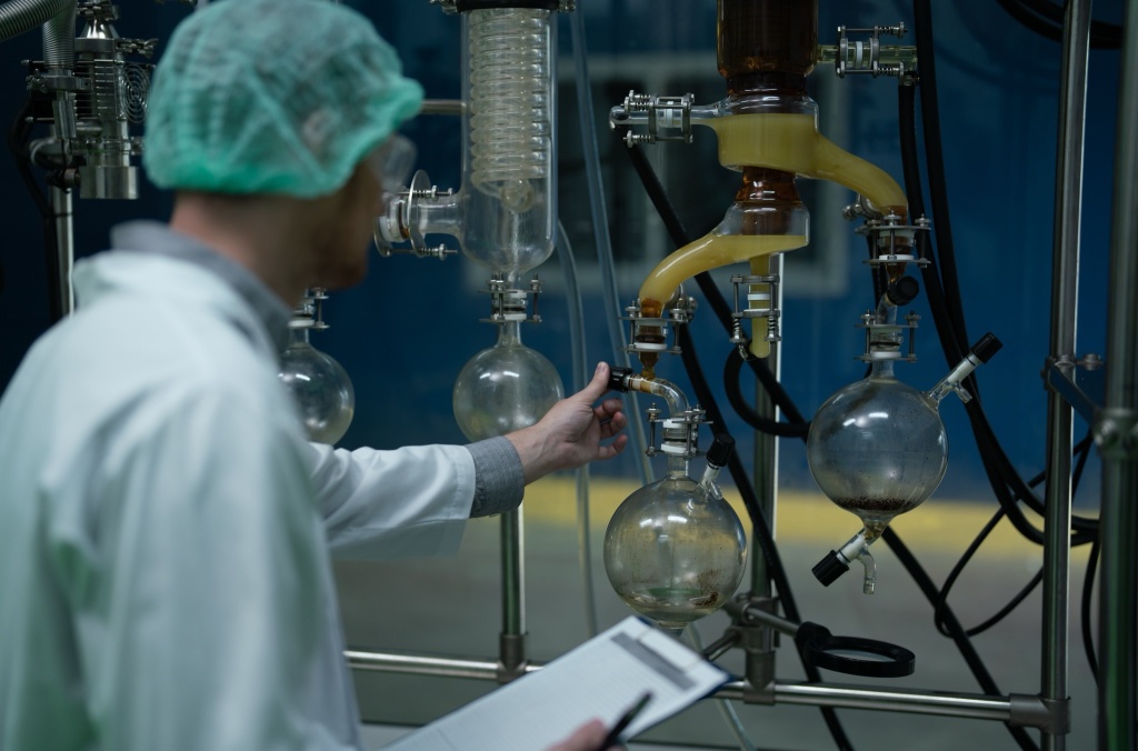 lab tech with cannabis extraction equipment for HTE