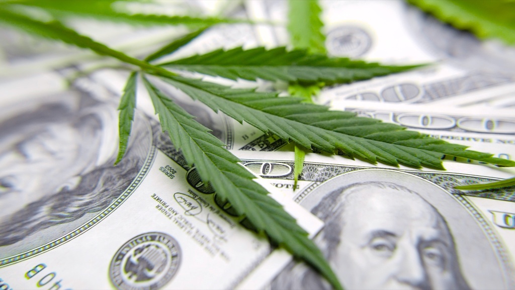 cannabis leaf over currency cannabis industry financial future in balance