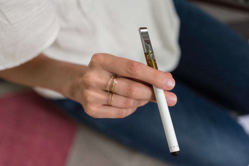 hand holding cannabis vape oil device