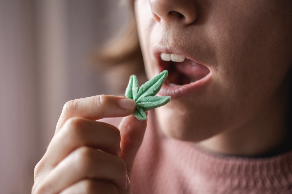 woman eating cannabis gummy for stress