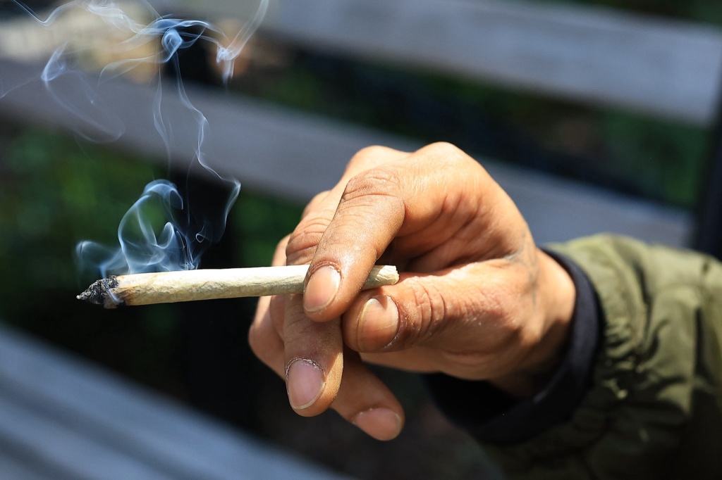 hand holding joint cannabis users relief from pain