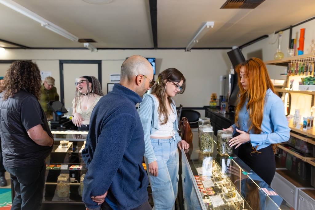 cannabis dispensary worker speaks with shoppers 4 20 HR mistakes can be costly