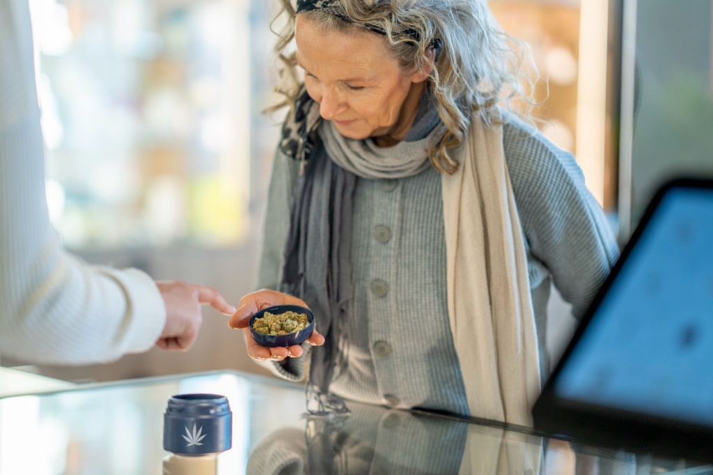 senior woman looking at cannabis aging well with cannabis book