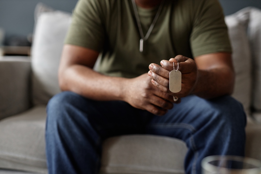 veteran holding dog tag cannabis access for veterans