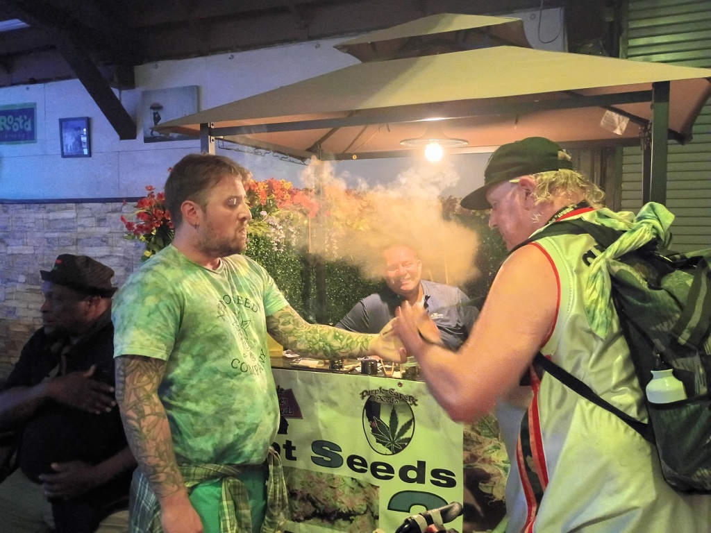 attendees pass a joint at rootd in 510 farmers market